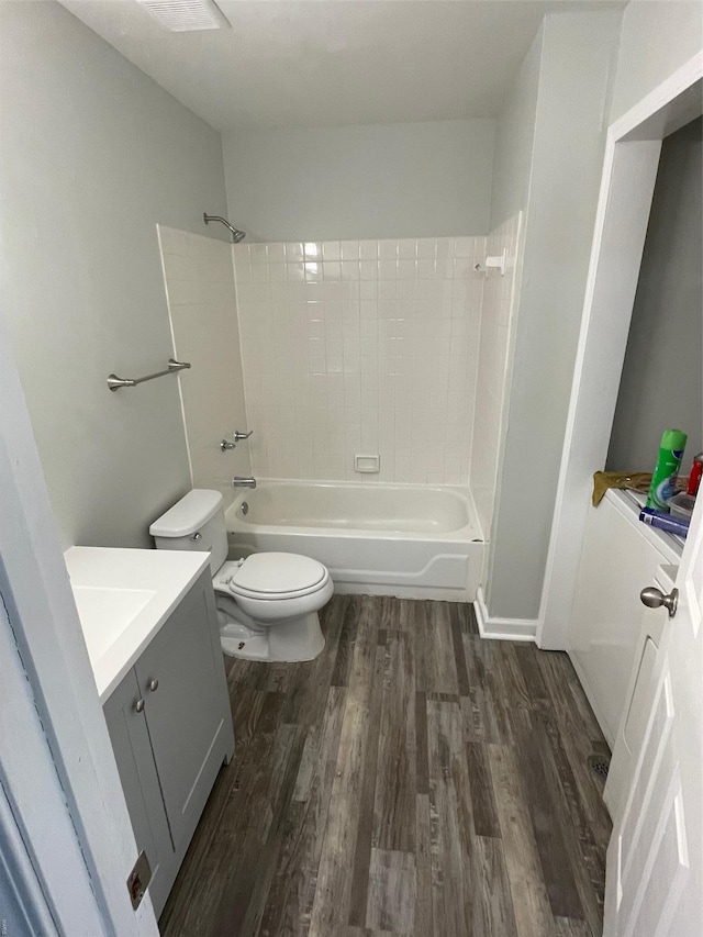 769 Walton Ave Unit 3, Saint Louis, MO 63108 - full bathroom featuring wood finished floors, toilet, vanity, and bathing tub / shower combination