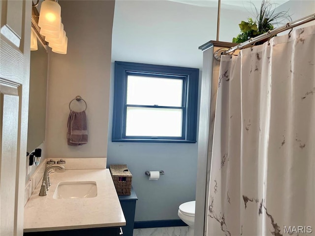 822 E Union Ave, Litchfield, IL 62056 - bathroom featuring toilet, vanity, marble look tile flooring, baseboards, and curtained shower