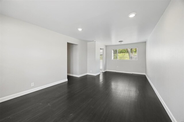 9218 Ellison Dr, Saint Louis, MO 63136 - spare room featuring dark wood-type flooring, baseboards, and recessed lighting