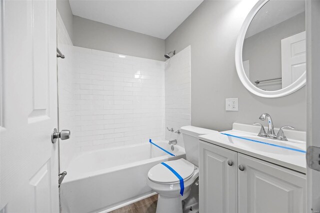 9218 Ellison Dr, Saint Louis, MO 63136 - bathroom featuring wood finished floors, toilet, vanity, and bathtub / shower combination