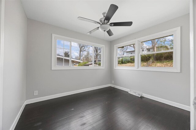 9218 Ellison Dr, Saint Louis, MO 63136 - spare room featuring dark wood finished floors, baseboards, and a ceiling fan