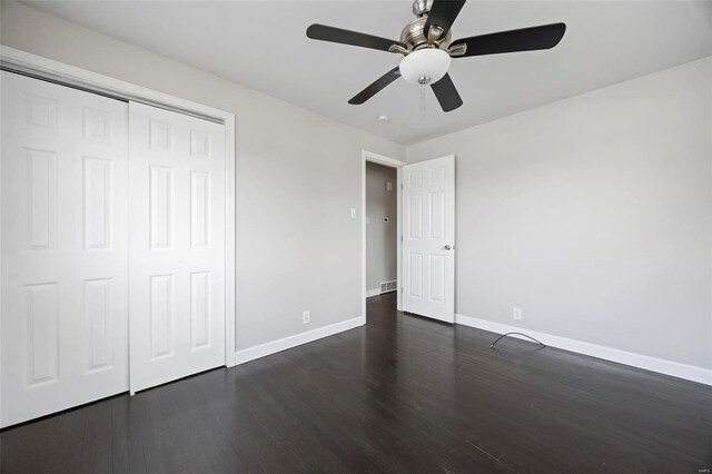 9218 Ellison Dr, Saint Louis, MO 63136 - unfurnished bedroom featuring baseboards, dark wood-style flooring, and a closet