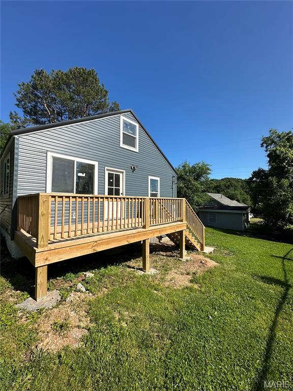 403 Broadway St, Waynesville, MO 65583 - back of property featuring a wooden deck and a lawn