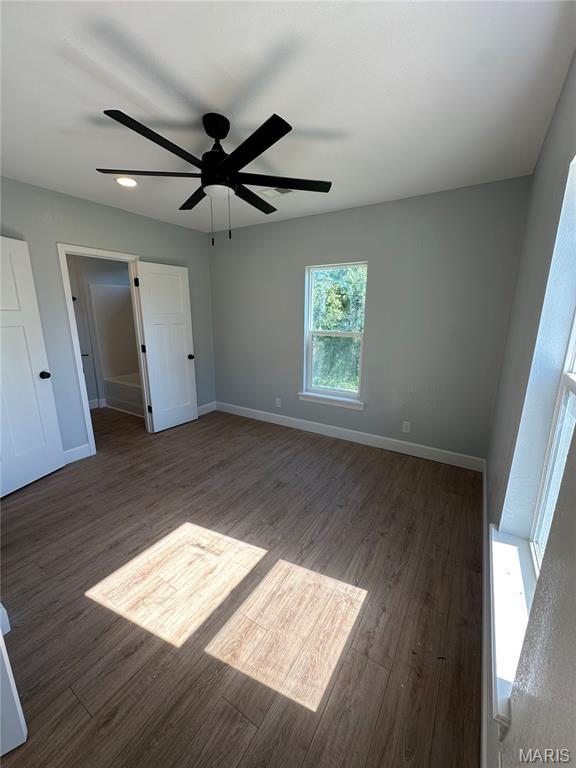 403 Broadway St, Waynesville, MO 65583 - unfurnished bedroom with wood finished floors, baseboards, and ceiling fan