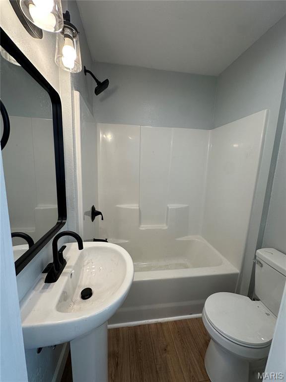 403 Broadway St, Waynesville, MO 65583 - full bath with wood finished floors, toilet, and shower / bath combination
