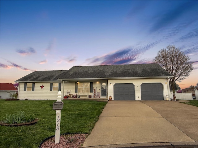 ranch-style house featuring covered porch, concrete driveway, a garage, and a front lawn