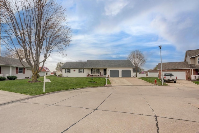 single story home featuring an attached garage, driveway, and a front lawn