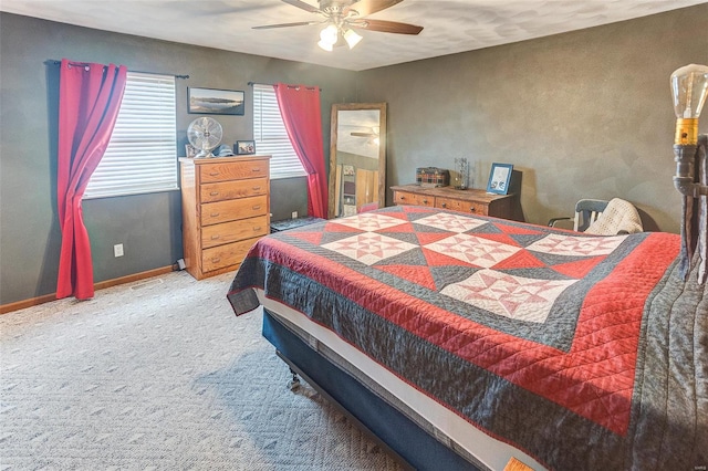 carpeted bedroom featuring baseboards and ceiling fan