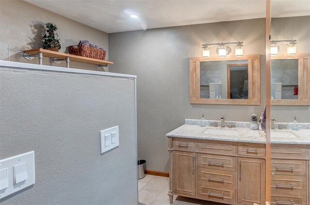 bathroom with tile patterned flooring and vanity