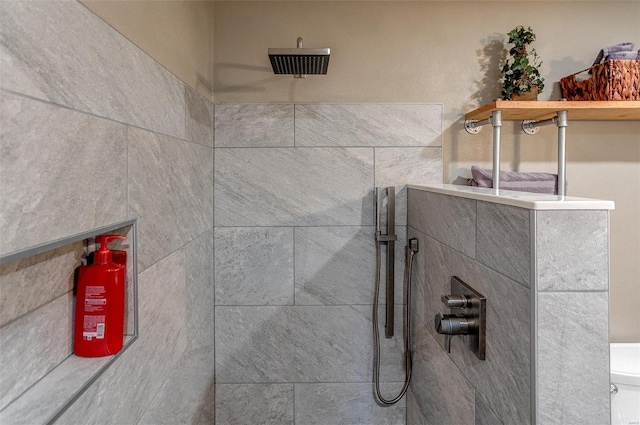 bathroom view of a tile shower and a fire extinguisher