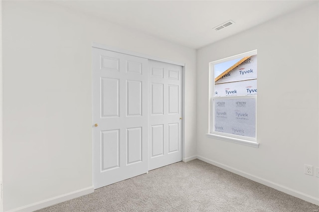407 Fleming Cir, Wentzville, MO 63385 - unfurnished bedroom with light carpet, baseboards, and a closet