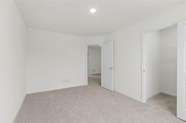 407 Fleming Cir, Wentzville, MO 63385 - unfurnished bedroom with carpet floors, a walk in closet, baseboards, and recessed lighting