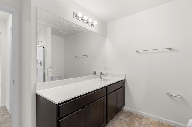 407 Fleming Cir, Wentzville, MO 63385 - bathroom featuring toilet, baseboards, and vanity