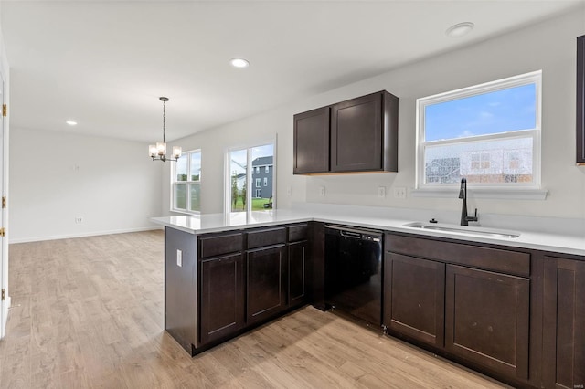 407 Fleming Cir, Wentzville, MO 63385 - kitchen featuring dishwasher, a sink, dark brown cabinets, light countertops, and recessed lighting