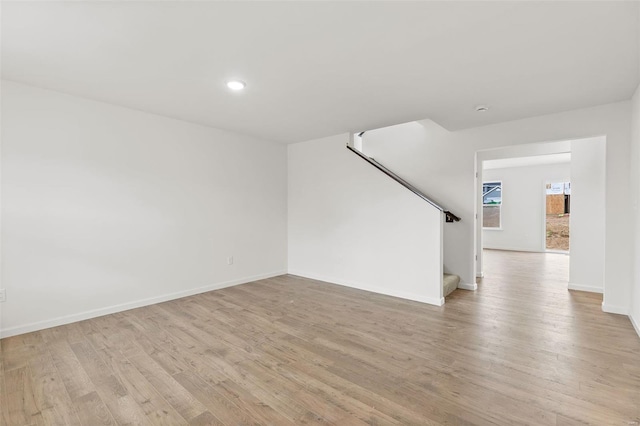 407 Fleming Cir, Wentzville, MO 63385 - unfurnished living room featuring stairway, light wood-style floors, baseboards, and recessed lighting