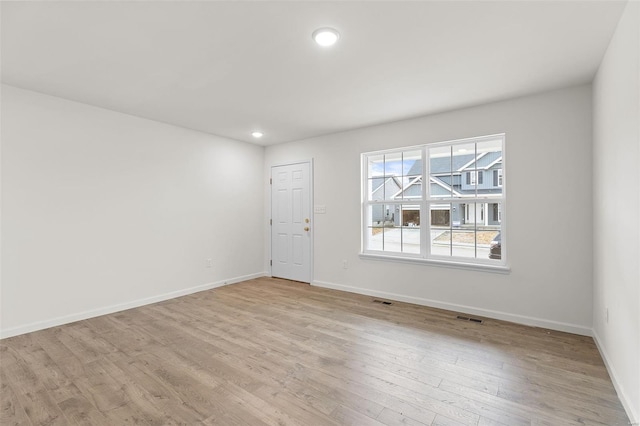 407 Fleming Cir, Wentzville, MO 63385 - unfurnished room with light wood-type flooring, baseboards, and recessed lighting