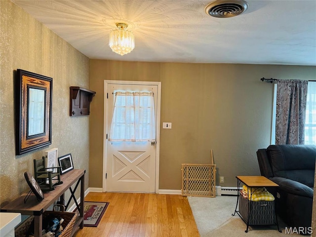 1423 Shelley Dr, Vandalia, IL 62471 - entryway featuring healthy amount of natural light, baseboard heating, light wood finished floors, baseboards, and a textured wall