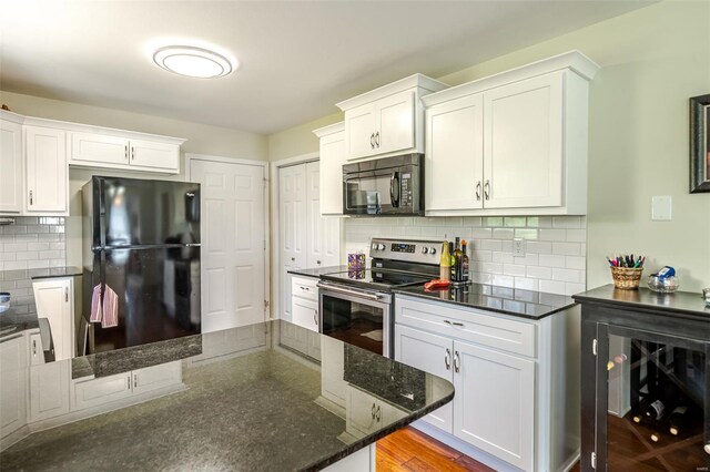8 Nick Ridge Dr, Washington, MO 63090 - kitchen featuring black appliances, decorative backsplash, dark stone counters, and white cabinets