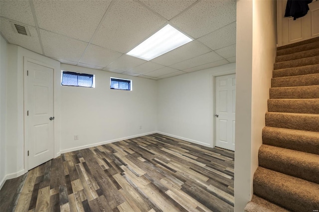 8 Nick Ridge Dr, Washington, MO 63090 - below grade area featuring a drop ceiling, dark wood-type flooring, stairs, and baseboards