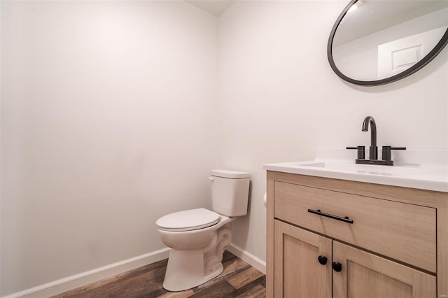 8 Nick Ridge Dr, Washington, MO 63090 - half bath featuring toilet, vanity, wood finished floors, and baseboards