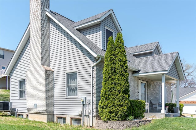 8 Nick Ridge Dr, Washington, MO 63090 - view of property exterior featuring a chimney, central AC, roof with shingles, and a yard