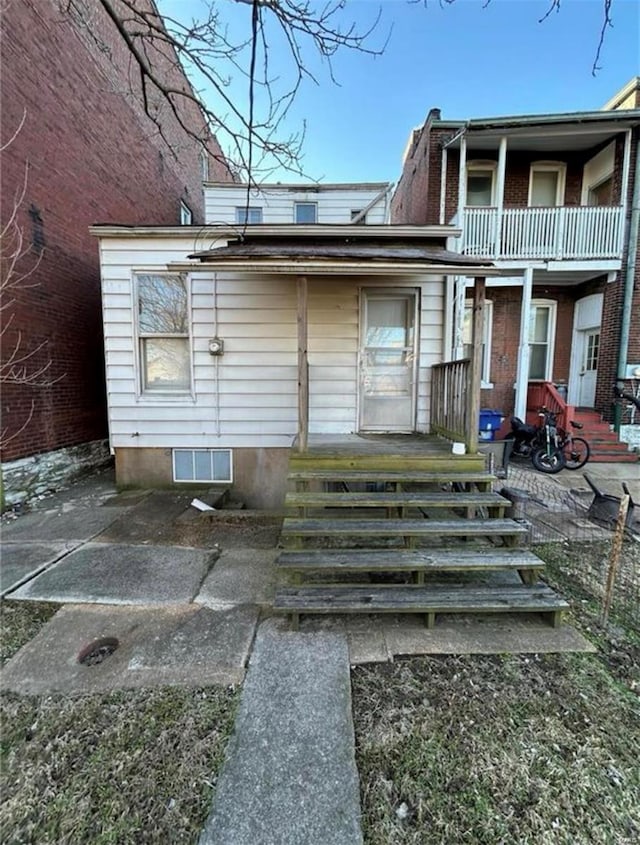 3449 Chippewa St, Saint Louis, MO 63118 - rear view of house with a balcony, a porch, and brick siding