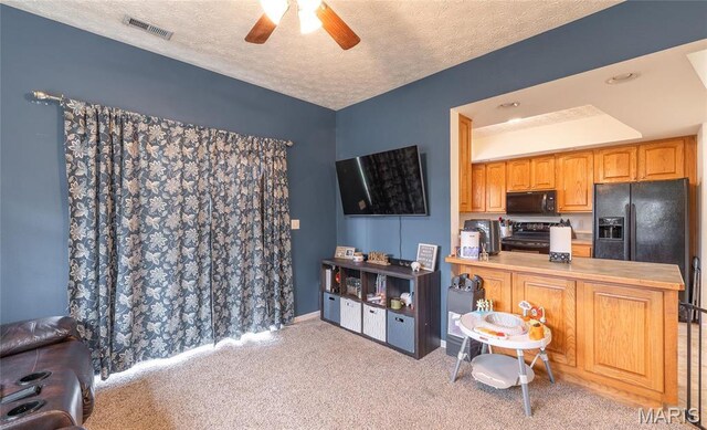 22354 Target Rd, Saint Robert, MO 65584 - kitchen with black appliances, a ceiling fan, a textured ceiling, carpet, and a peninsula