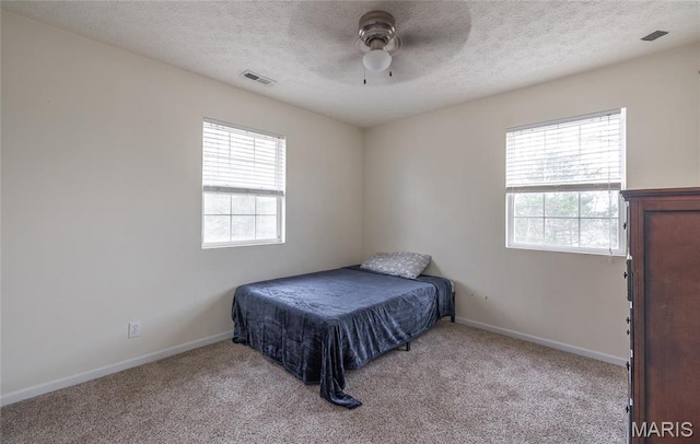 22354 Target Rd, Saint Robert, MO 65584 - carpeted bedroom featuring a textured ceiling, baseboards, and a ceiling fan