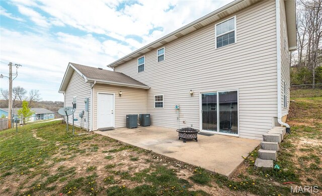 22354 Target Rd, Saint Robert, MO 65584 - back of house featuring a patio area, an outdoor fire pit, and central AC