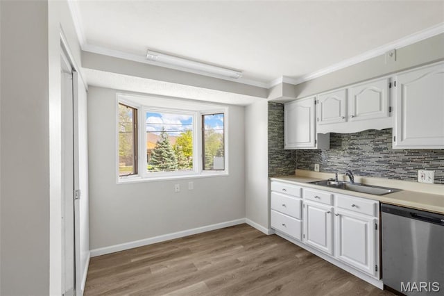 1220 Spring Valley Dr, Florissant, MO 63033 - kitchen featuring stainless steel dishwasher, a sink, white cabinetry, crown molding, and light countertops