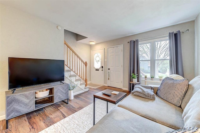 10161 Squire Meadows Dr Unit C, Saint Louis, MO 63123 - living area with stairway, wood finished floors, and baseboards