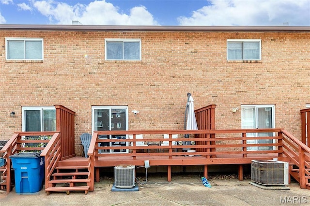10161 Squire Meadows Dr Unit C, Saint Louis, MO 63123 - rear view of house with central AC, a wooden deck, and brick siding