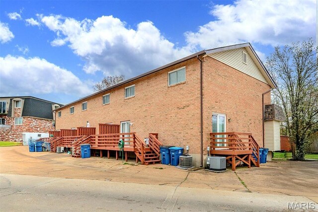 10161 Squire Meadows Dr Unit C, Saint Louis, MO 63123 - back of property with brick siding, a deck, and cooling unit