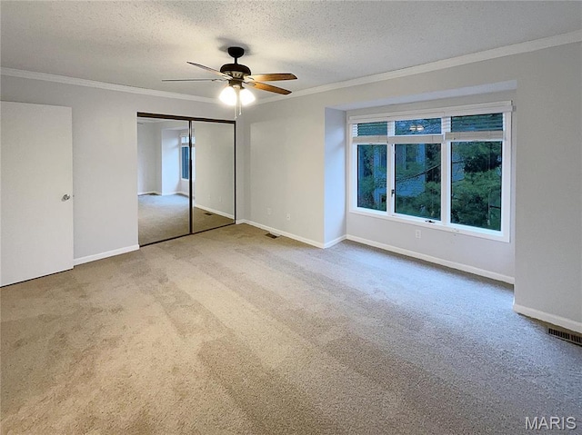 26 Thistledale Ct Unit H, Saint Peters, MO 63376 - unfurnished bedroom with carpet, ornamental molding, a textured ceiling, a closet, and a ceiling fan