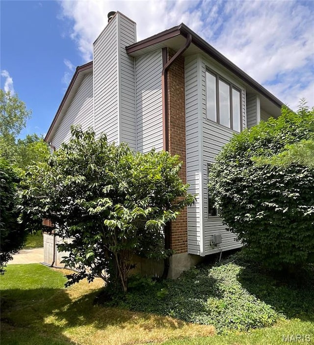 26 Thistledale Ct Unit H, Saint Peters, MO 63376 - view of property exterior featuring a chimney