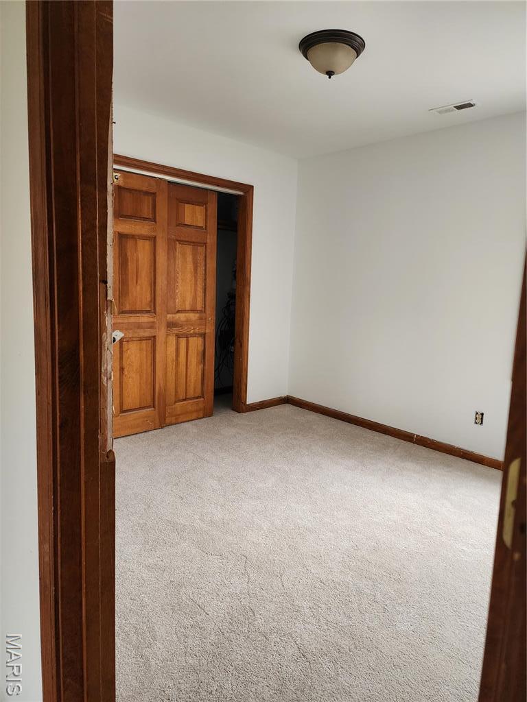 1414 Reale Ave, Saint Louis, MO 63138 - carpeted empty room with baseboards