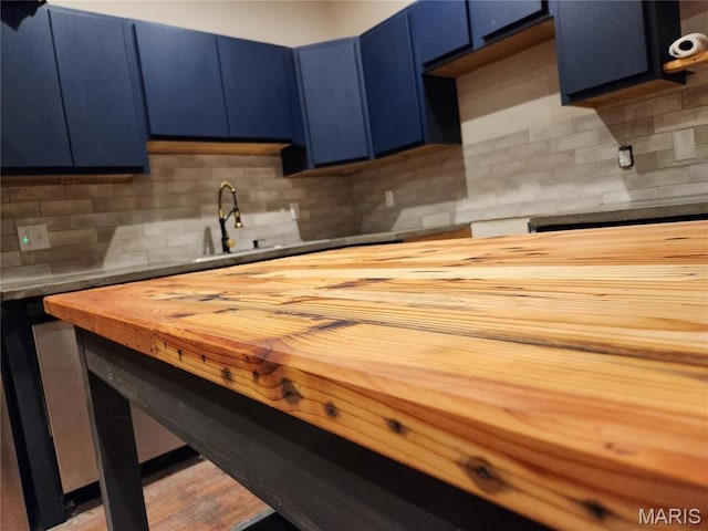 4713 Virginia Ave, Saint Louis, MO 63111 - kitchen featuring wood counters, blue cabinets, and tasteful backsplash