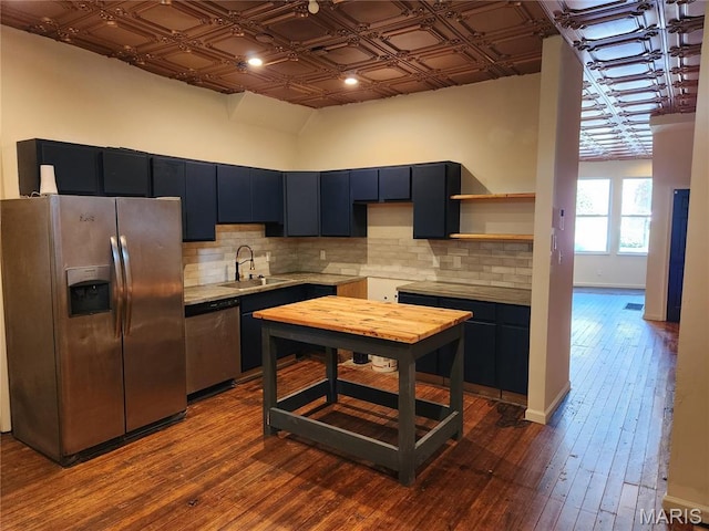 4713 Virginia Ave, Saint Louis, MO 63111 - kitchen with stainless steel appliances, a sink, tasteful backsplash, an ornate ceiling, and dark wood-style floors