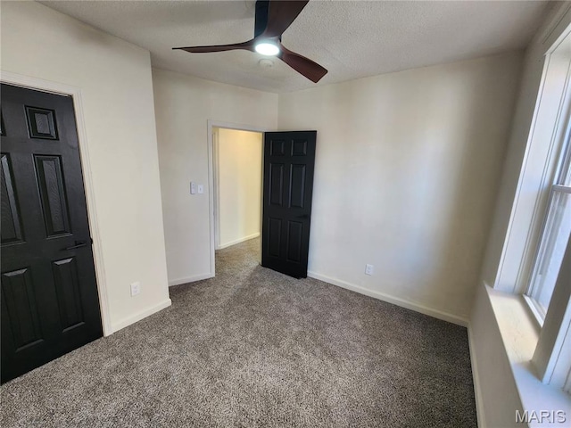 4713 Virginia Ave, Saint Louis, MO 63111 - unfurnished bedroom with carpet, baseboards, ceiling fan, and a textured ceiling