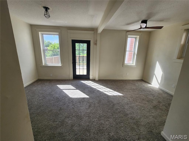 4713 Virginia Ave, Saint Louis, MO 63111 - carpeted empty room featuring a textured ceiling, plenty of natural light, a ceiling fan, and baseboards
