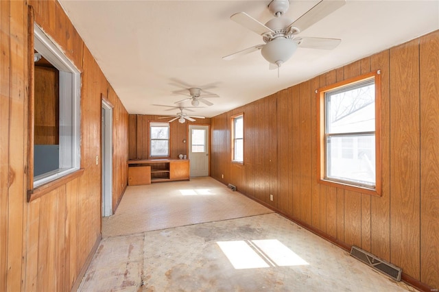 104 E Jefferson Ave, Richland, MO 65556 - unfurnished room with ceiling fan, wooden walls, and baseboards