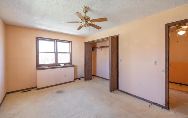 104 E Jefferson Ave, Richland, MO 65556 - unfurnished bedroom with a textured ceiling, baseboards, a closet, and a ceiling fan