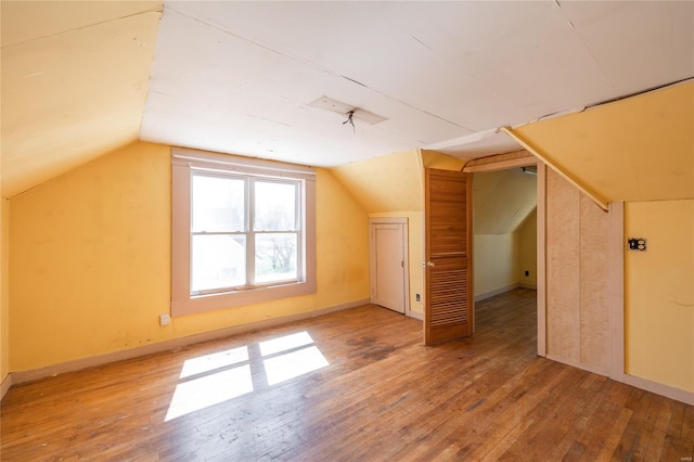 104 E Jefferson Ave, Richland, MO 65556 - additional living space featuring wood-type flooring, vaulted ceiling, and baseboards