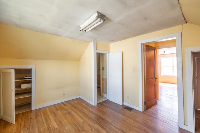 104 E Jefferson Ave, Richland, MO 65556 - bonus room with vaulted ceiling, wood-type flooring, and baseboards