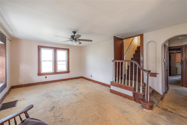 104 E Jefferson Ave, Richland, MO 65556 - unfurnished room featuring arched walkways, ceiling fan, stairs, and baseboards