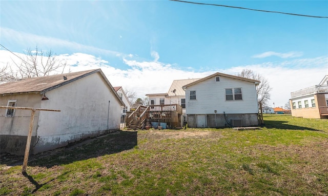 104 E Jefferson Ave, Richland, MO 65556 - rear view of property featuring a yard, stairway, a wooden deck, and central air condition unit
