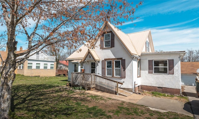 104 E Jefferson Ave, Richland, MO 65556 - view of front of home featuring a deck, crawl space, metal roof, and a front yard