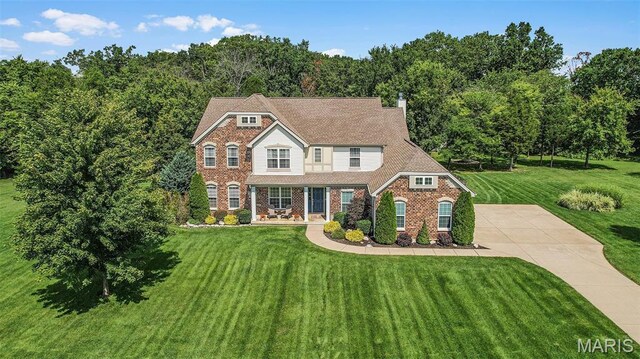 view of front of home featuring a front yard and brick siding