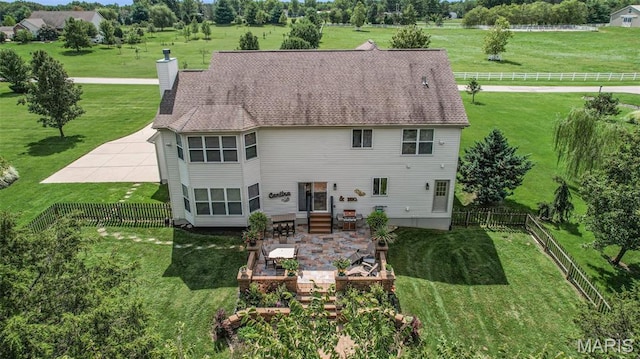 rear view of house featuring a chimney, a patio, and entry steps