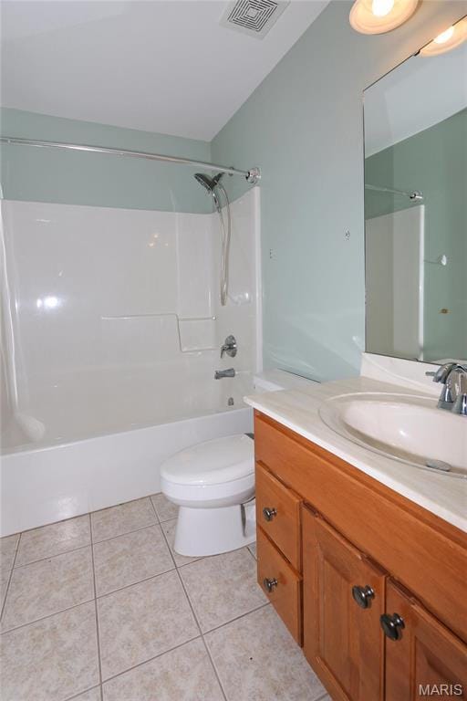 bathroom featuring tile patterned floors, toilet, vanity, and bathing tub / shower combination